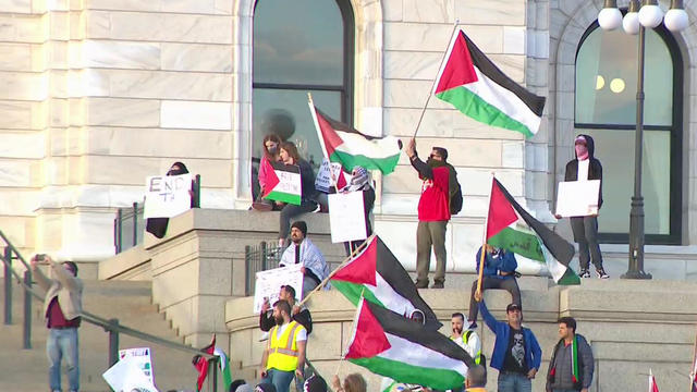 protesters hold flag of palestine on the steps of the minnesota capitol building 