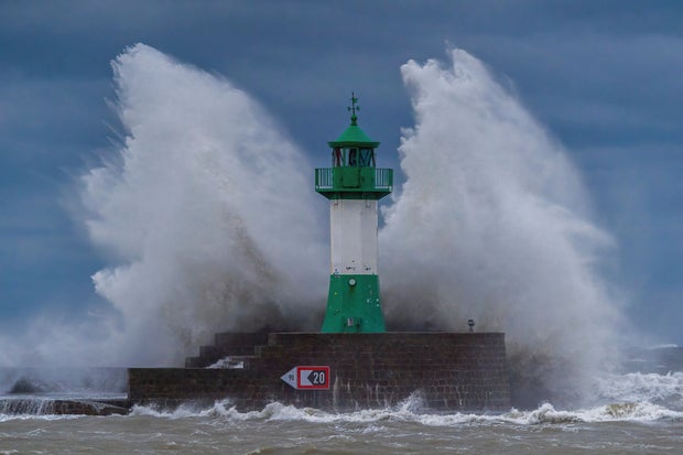 Waves from the Baltic Sea lash against the lighthouse on the eastern pier during a severe storm depression, in Sassnitz, Germany, Oct. 20, 2023