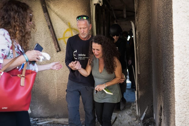 Hadas Kalderon, whose children have been taken hostage and whose mother and niece have been killed, breaks down in tears while looking at the burnt out home of her late mother on Oct. 30, 2023 in Kibbutz Nir Oz, Israel