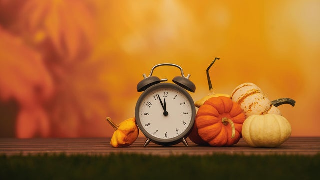 Time for Fall. Clock with pumpkins. Space for text