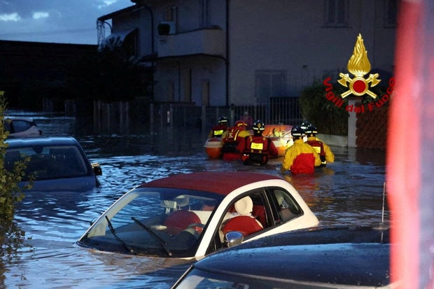 Italian firefighters work in flooded streets in Tuscany region