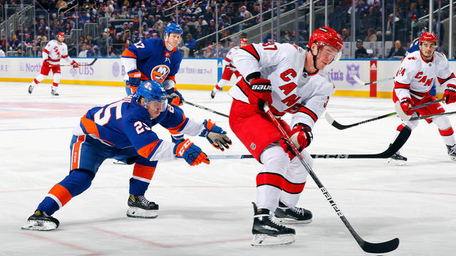 Andrei Svechnikov #37 of the Carolina Hurricanes moves past Sebastian Aho #25 of the New York Islanders during the third period at UBS Arena on November 04, 2023 in Elmont, New York. 