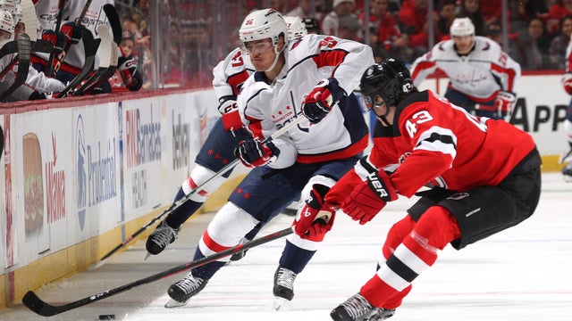 Nicolas Aube-Kubel #96 of the Washington Capitals and Luke Hughes #43 of the New Jersey Devils go after the puck during the first period at Prudential Center on November 10, 2023 in Newark, New Jersey. 