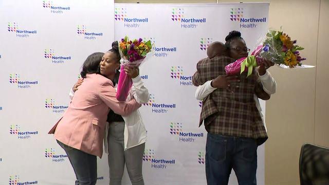 Brock Calhoun and his wife hug Dr. Michelle Chester, director of Northwell Employee Health Services, and Northwell nurse Kaya Wynter. 