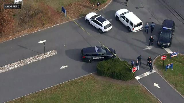 An aerial view of police vehicles and crime scene tape blocking off a PNC Bank driveway. 