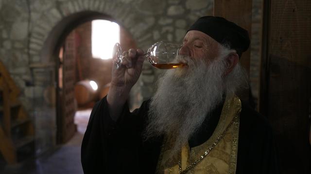 Monk drinking wine in Georgia 