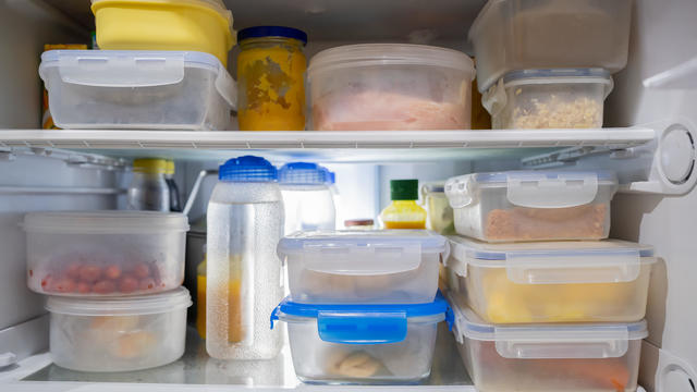 Storing food in plastic boxes in refrigerator 