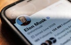 Elon Musk's X (formerly Twitter) bio is seen on a cellphone screen 