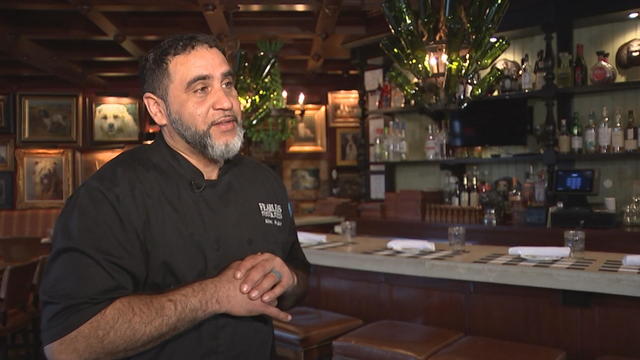 White Dog Cafe executive chef Albert Alverado speaks to a reporter in the restaurant 