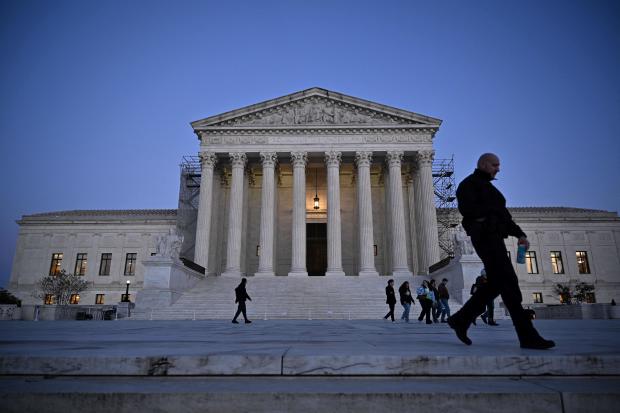 People walk past the Supreme Court in Washington, D.C., on Nov. 13, 2023. 