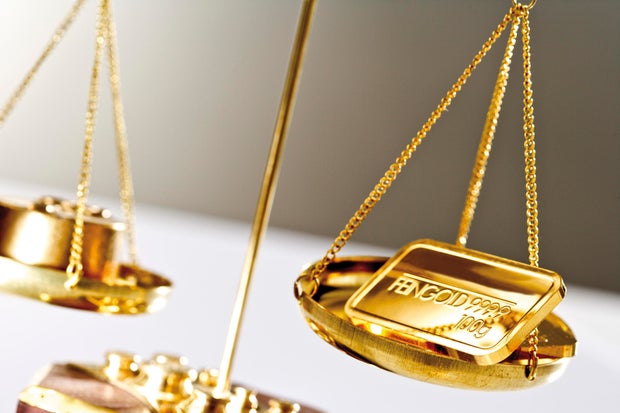 Gold bar on a a pair of scales