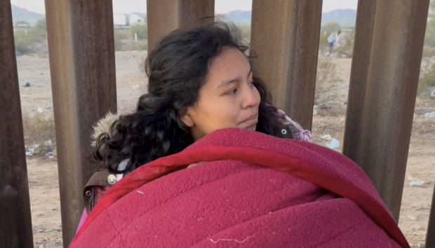 Daniela Segura Salgado waits along the wall separating the U.S. and Mexico near Lukeville, Arizona, on Thursday, Dec. 7, 2023. 