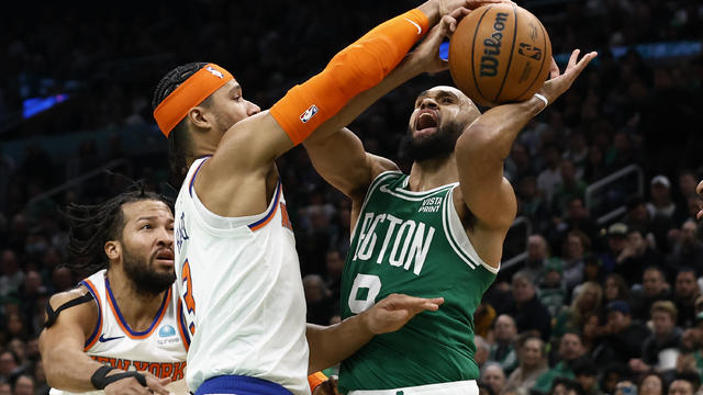 Derrick White #9 of the Boston Celtics is stopped going to the basket by Josh Hart #3 of the New York Knicks during the second half at TD Garden on December 8, 2023 in Boston, Massachusetts. 