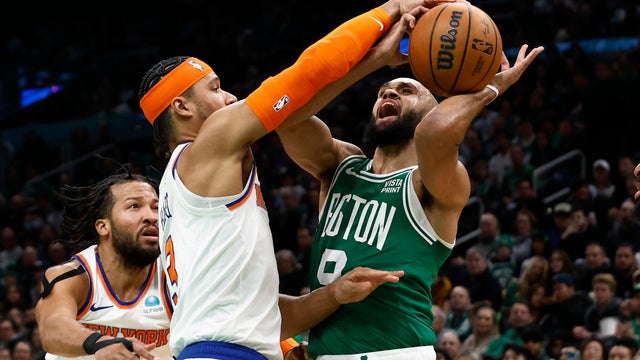 Derrick White #9 of the Boston Celtics is stopped going to the basket by Josh Hart #3 of the New York Knicks during the second half at TD Garden on December 8, 2023 in Boston, Massachusetts.