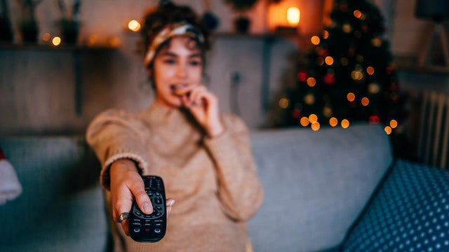 Woman watching tv at home