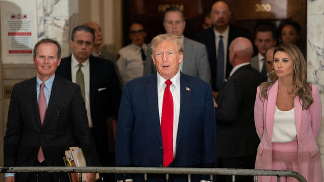 Flanked by his attorneys, former President Donald Trump speaks to the media while attending his trial in New York State Supreme Court on Dec. 7, 2023. 