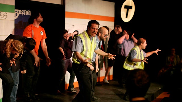 Cambridge, MA - Timothy Hoover playing the part of 'T-Cop Nielsen' performs a song with the ensemble during ImprovBoston's 'T: An MBTA Musical' on Saturday July 2,2011. Photo by Matthew Healey 