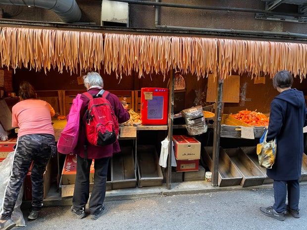 Farmer sells her food for pennies in a trendy Tokyo district to help young people walking around hungry
