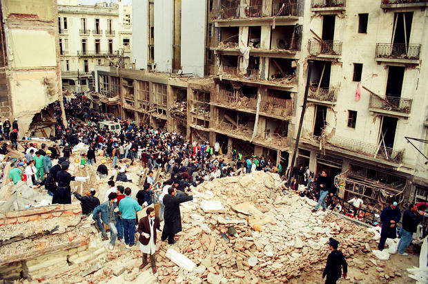 Rescue workers sift through the rubble at the site of a bombing at the Asociación Mutual Israelita Argentina in Buenos Aires, Argentina, on July 18, 1994. 