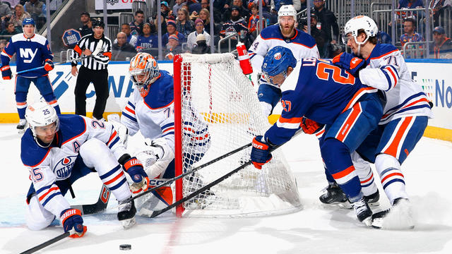 The Edmonton Oilers defend against Anders Lee #27 of the New York Islanders during the second period at UBS Arena on December 19, 2023 in Elmont, New York. 