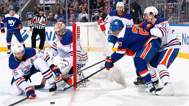The Edmonton Oilers defend against Anders Lee #27 of the New York Islanders during the second period at UBS Arena on December 19, 2023 in Elmont, New York.