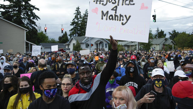 Community members attend a vigil at the intersection where Manuel Ellis died in Tacoma Police custody in Tacoma, Washington, on June 3, 2020. 
