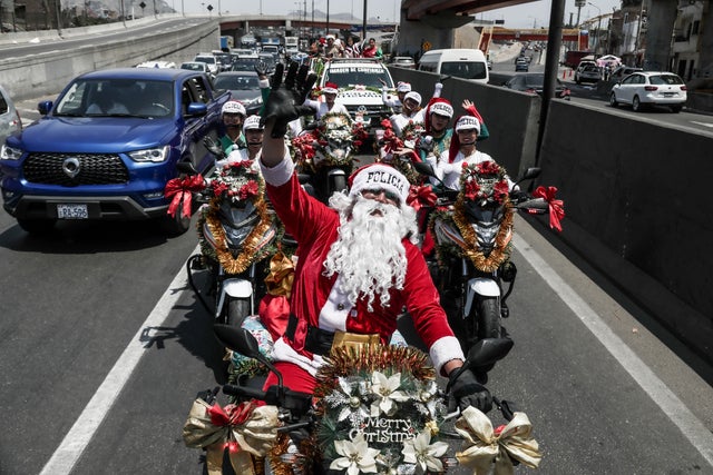 Police officers from the traffic squad in Christmas costumes walk through the streets of Lima 