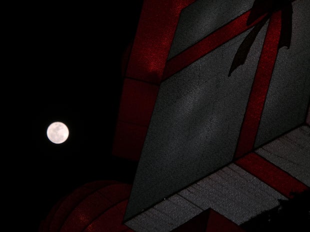 A bright full moon lights up the Yuletide sky of December 25