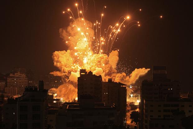 A missile explodes in Gaza City during an Israeli air strike 