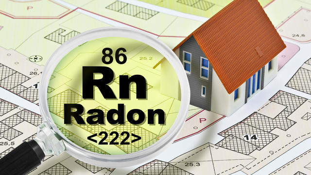 The danger of radon gas in our homes - concept with presence of radon gas under the soil of our cities and buildings with magnifying glass 