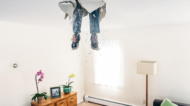 Man breaks ceiling drywall while doing DIY 