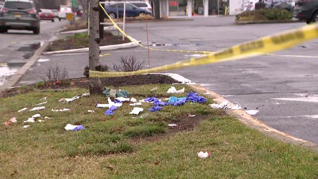 Litter in a grassy area near a parking lot off Route 4 East under crime scene tape. 