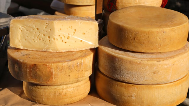 tasty mature cheese with holes for sale in the market