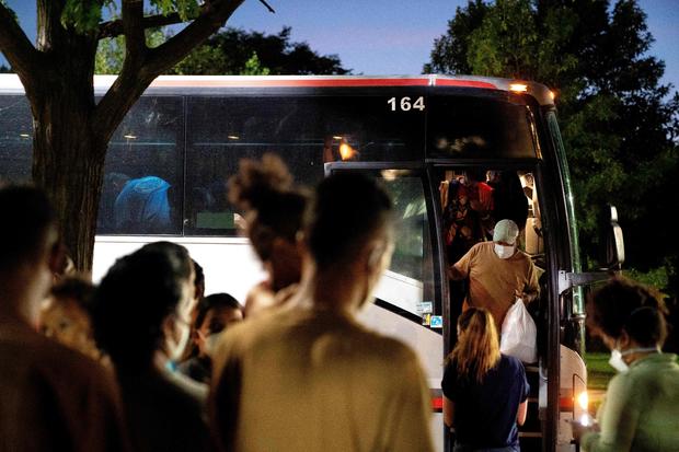 Migrants from Venezuela, who boarded a bus in Del Rio, Texas, disembark in Washington, D.C 