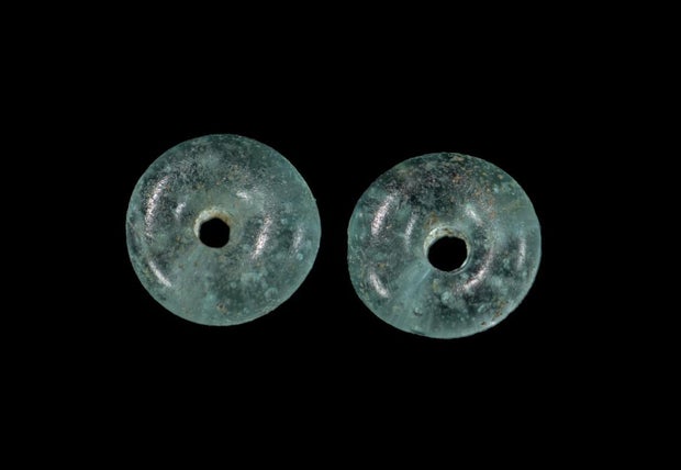 Turquoise glass beads found in the ancient cemetery