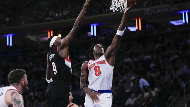 New York Knicks' OG Anunoby (8) drives past Portland Trail Blazers' Jerami Grant (9) during the second half of an NBA basketball game Tuesday, Jan. 9, 2024, in New York. The Knicks won 112-84. 