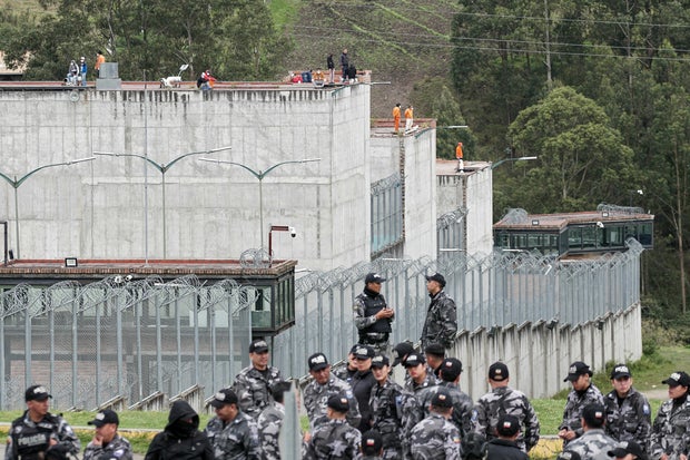 Police forces stand guard outside the Turi prison as inmates hold prison guards hostage, in Cuenca, Ecuador, on January 8, 2024. Following the escape of the head of the Los Choneros drug gang, incidents were reported in several of the country's prisons