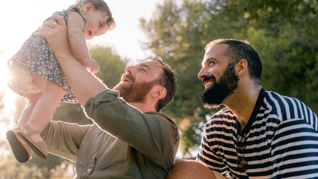 Happy dads thanks to surrogacy, two dads and their cherished daughter, a dream come true. 
