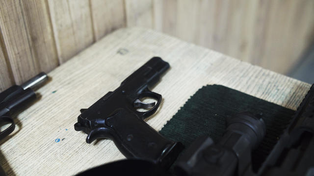 Pistol on table in an indoor shooting range 