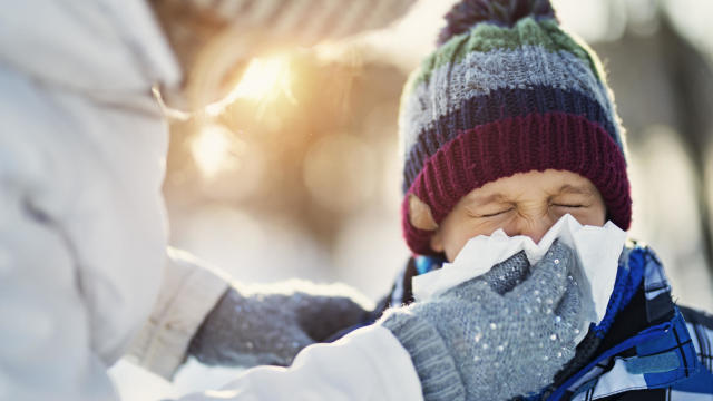 Sneezing coughing ill young using paper napkin, having runny nose, blowing her nose. Coronavirus, infectious disease, flu, cold. 