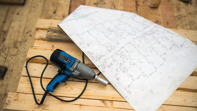 Electric Power Drill And Architectural Plans 