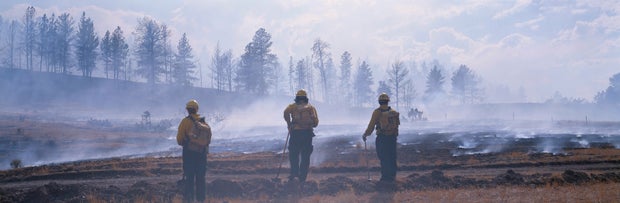 Firefighters on the scene of a smoky wildfire in Montana