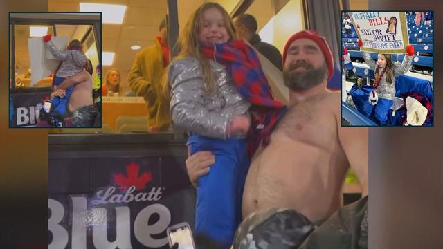 Jason Kelce holds up Taylor Swift superfan, Ella Piazza, to see her idol at Chiefs-Bills game. 