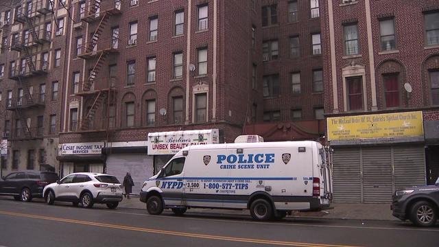 An NYPD crime scene unit vehicle parked outside a Brooklyn apartment building. 