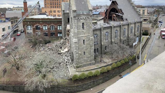 The side of a church. Half of the roof has collapsed. 