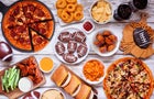 Super Bowl or football theme food table scene, above view on white wood 