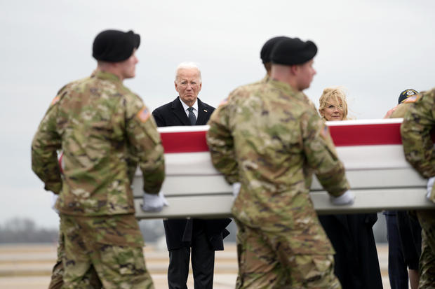President Biden stands as an Army carry team moves the transfer case containing the remains of Sgt. Breonna Alexsondria Moffett at Dover Air Force Base on Friday, Feb. 2, 2024. 
