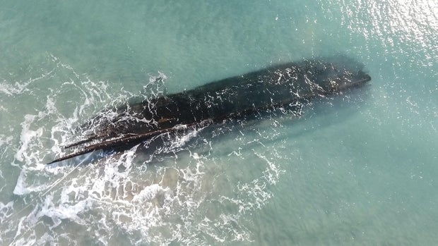Mysterious shipwreck washes up on snowy Canada shores, prompting race to salvage vessel being pummeled by the ocean