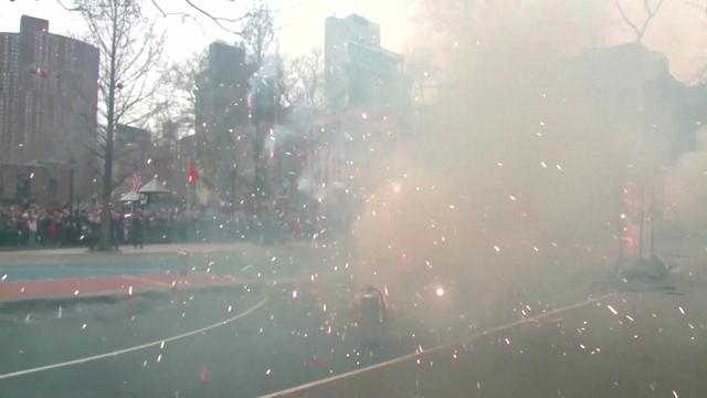 Firecrackers are set off on a basketball court. 