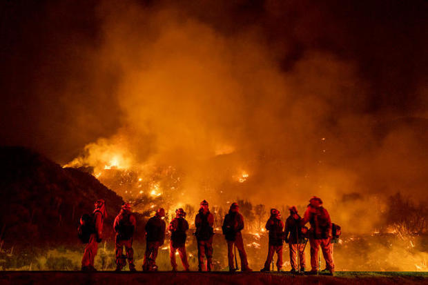 September 9: A group of inmate firefighter watch as the El Dorado Fire burns a hillside near homes in Mountain Home Village, California, inside the San Bernardino National Forest, September 9, 2020. 